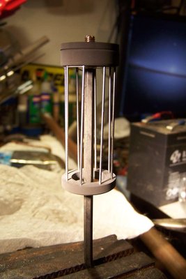 The cool grid.  The graphite ends help cool it, have a high radiation for heat.  .040" tungsten rods about 2.5" long.  Slightly twisted, a mistake in making it, but maybe that makes it work better?