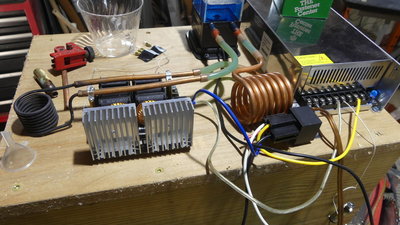 Induction annealer, around 1kw.  Custom coil of small tubing.  The big one is just to radiate heat, it came with the source.  I still have to build the solenoid trap door to drop the hot brass when it's done.