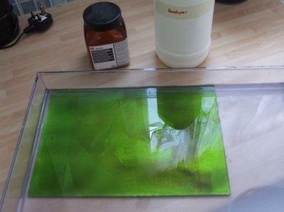 It is then washed in developer, which removes the photosensitive ink that was exposed to light. Stubborn photoresist is teased off using a brush.